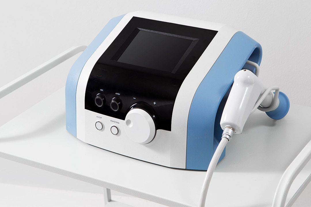Blue and white medical shockwave machine with a cord, relevant for Medical Directors considering device leasing options.